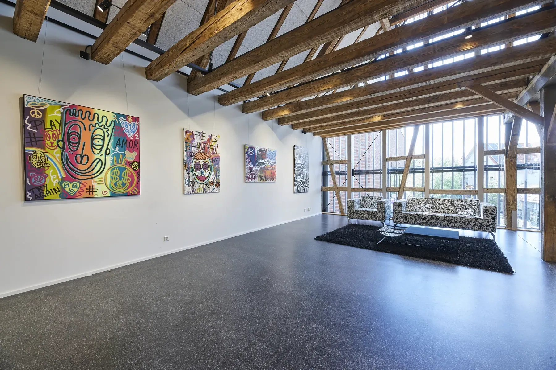 A gallery hung with Romulo Kuranyi paintings